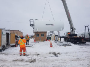 PSL Truck at a oil and gas job site moving a petroleum tank